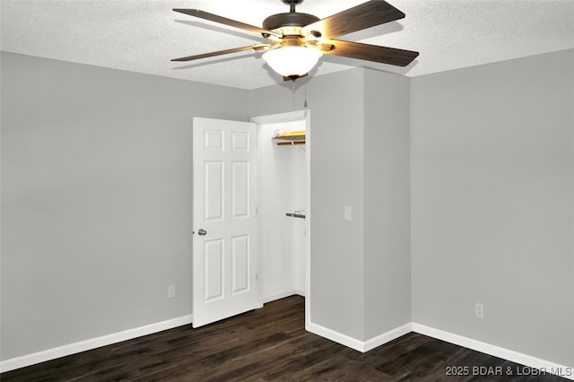 712 Passover Rd, Osage Beach, MO 65065 - unfurnished bedroom featuring dark wood finished floors, a textured ceiling, and ceiling fan