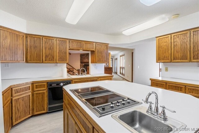 948 Cable Point Dr, Climax Springs, MO 65324 - kitchen featuring dishwasher, stovetop with downdraft, light countertops, brown cabinetry, and a textured ceiling