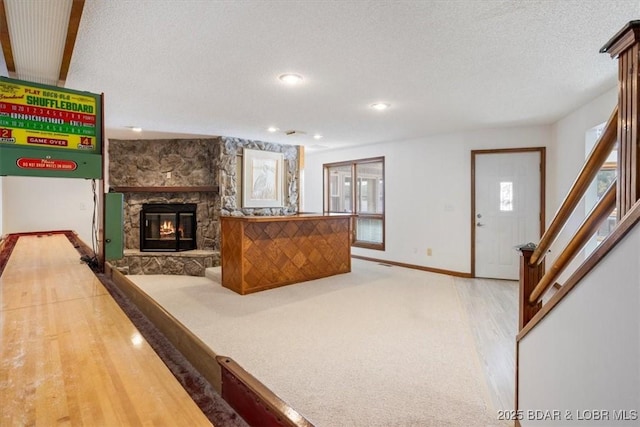 948 Cable Point Dr, Climax Springs, MO 65324 - living room featuring a stone fireplace, a textured ceiling, stairway, recessed lighting, and wood finished floors
