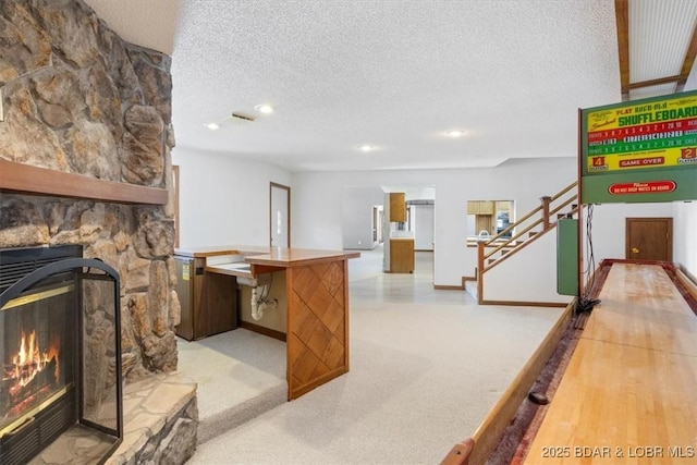 948 Cable Point Dr, Climax Springs, MO 65324 - unfurnished living room featuring a textured ceiling, stairway, recessed lighting, and a stone fireplace