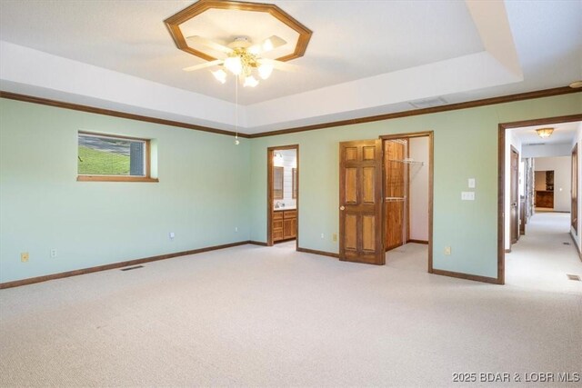 948 Cable Point Dr, Climax Springs, MO 65324 - unfurnished bedroom with light colored carpet, a spacious closet, a raised ceiling, ensuite bath, and crown molding
