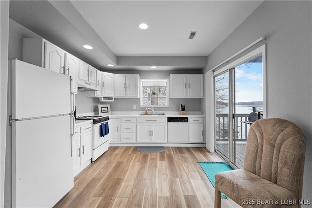 6504 Avalon Park, Osage Beach, MO 65065 - kitchen featuring white appliances, under cabinet range hood, recessed lighting, white cabinetry, and light countertops