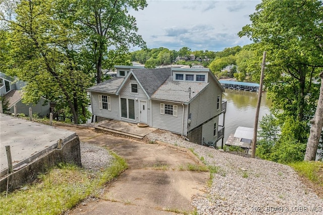 6504 Avalon Park, Osage Beach, MO 65065 - view of front facade featuring a water view, roof with shingles, and a dock