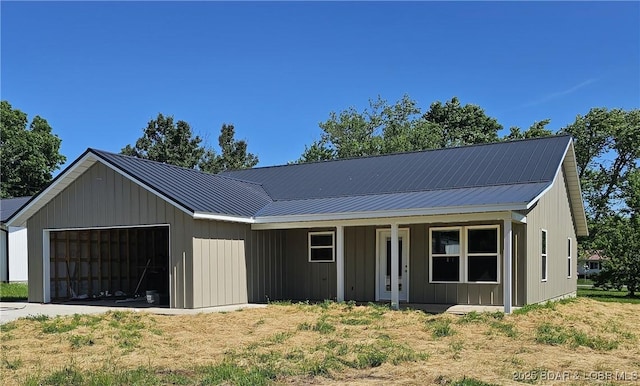 501 W 12th St, Eldon, MO 65026 - view of front facade with a garage and a metal roof