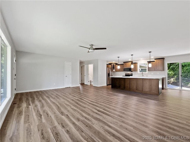 326 State Rd W, Macks Creek, MO 65786 - unfurnished living room featuring wood finished floors and baseboards