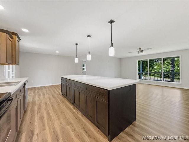 326 State Rd W, Macks Creek, MO 65786 - kitchen featuring light wood finished floors, healthy amount of natural light, range, light countertops, and recessed lighting