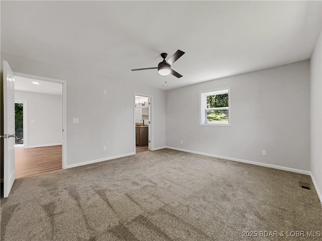 326 State Rd W, Macks Creek, MO 65786 - unfurnished bedroom with carpet floors, connected bathroom, and ceiling fan