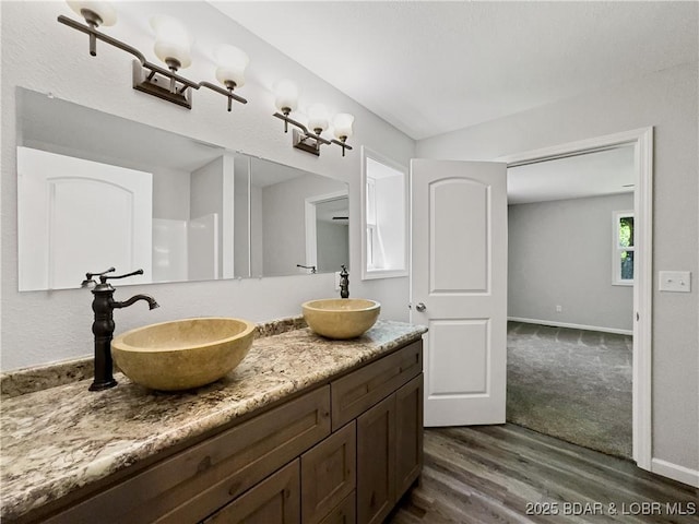 326 State Rd W, Macks Creek, MO 65786 - bathroom featuring wood finished floors and double vanity