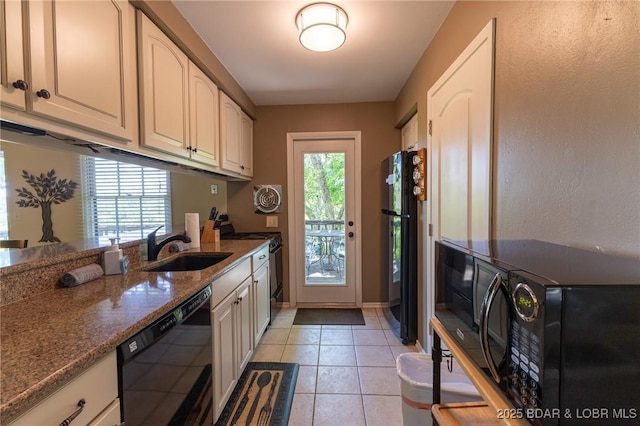 415 Staniel Cay Dr, Osage Beach, MO 65065 - kitchen featuring black appliances, dark stone counters, and light tile patterned flooring