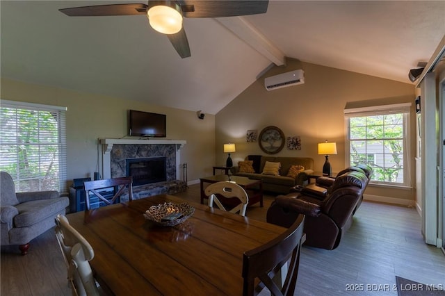 415 Staniel Cay Dr, Osage Beach, MO 65065 - dining area featuring a wall mounted air conditioner, wood finished floors, a fireplace, and a ceiling fan
