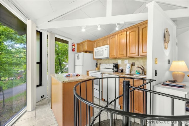 146 Tree Top Dr Unit 8, Four Seasons, MO 65049 - kitchen with white appliances, decorative backsplash, light stone countertops, light tile patterned floors, and a kitchen island