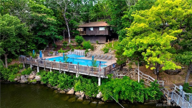 146 Tree Top Dr Unit 8, Four Seasons, MO 65049 - rear view of property featuring stairs, a community pool, and a deck with water view