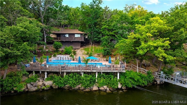 146 Tree Top Dr Unit 8, Four Seasons, MO 65049 - rear view of property with a community pool and a water view