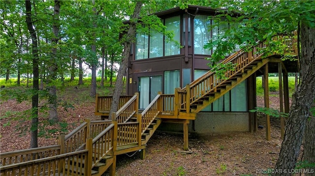 146 Tree Top Dr Unit 8, Four Seasons, MO 65049 - back of house with stairway, a wooden deck, and a sunroom