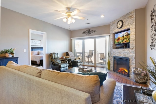464 Cedar Heights Dr Unit 3G, Camdenton, MO 65020 - living area featuring ceiling fan, a stone fireplace, and wood finished floors