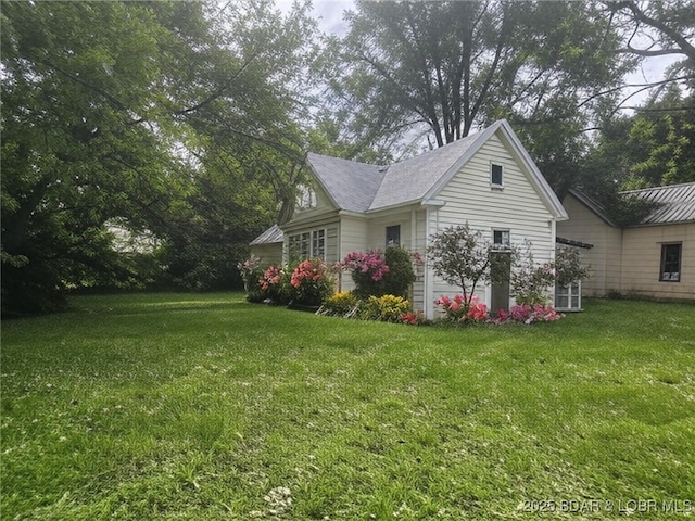 412 Maple St, Eldon, MO 65026 - view of property exterior with a lawn