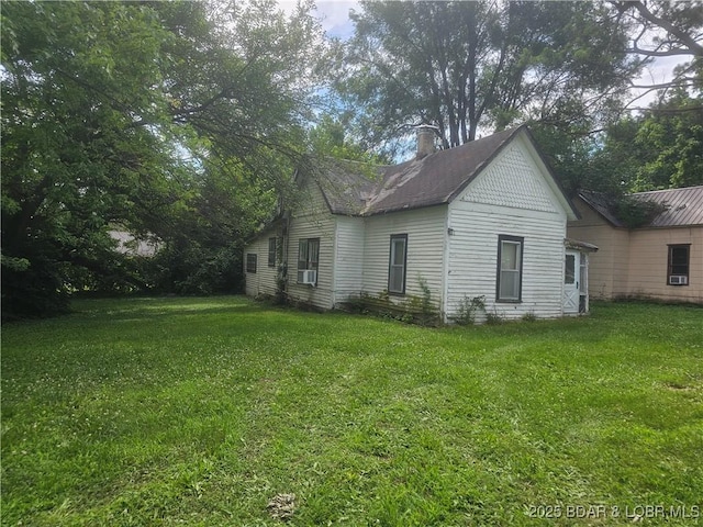 412 Maple St, Eldon, MO 65026 - back of house with a lawn, a chimney, and cooling unit