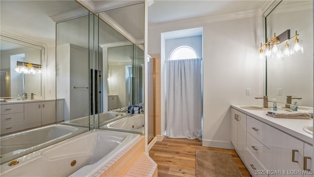 2268 Breezy Acres Rd, Osage Beach, MO 65065 - bathroom with a tub with jets, double vanity, wood finished floors, a shower stall, and ornamental molding