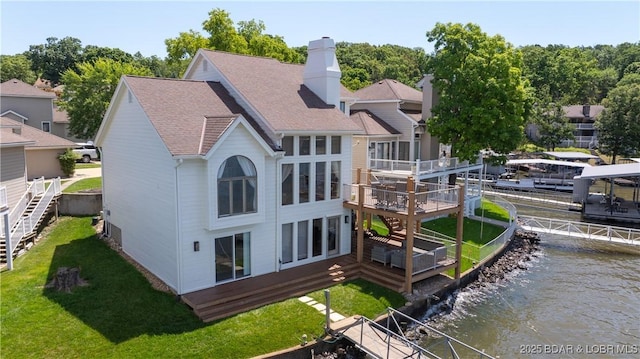 2268 Breezy Acres Rd, Osage Beach, MO 65065 - back of house featuring a deck with water view, a shingled roof, stairway, a chimney, and a yard