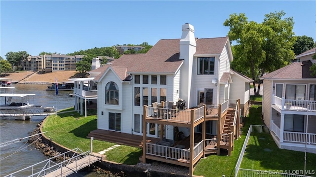 2268 Breezy Acres Rd, Osage Beach, MO 65065 - back of house with a water view, a chimney, a yard, and a shingled roof