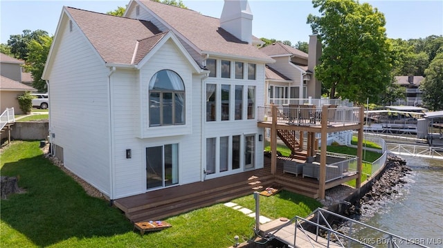 2268 Breezy Acres Rd, Osage Beach, MO 65065 - back of property with a deck with water view, stairway, a shingled roof, a chimney, and a yard
