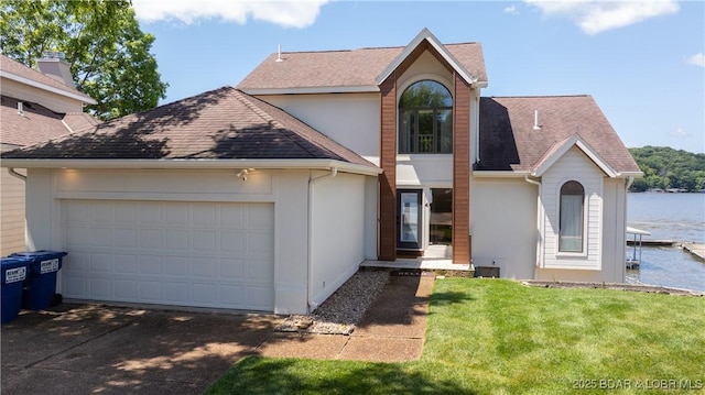 2268 Breezy Acres Rd, Osage Beach, MO 65065 - view of front of house featuring an attached garage, driveway, a water view, a front yard, and stucco siding