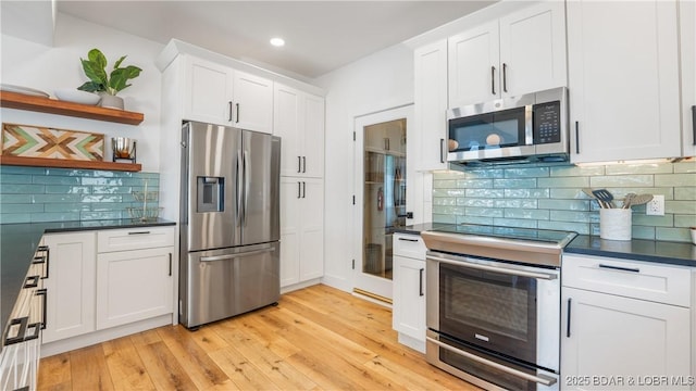 2268 Breezy Acres Rd, Osage Beach, MO 65065 - kitchen featuring appliances with stainless steel finishes, open shelves, dark countertops, white cabinets, and recessed lighting