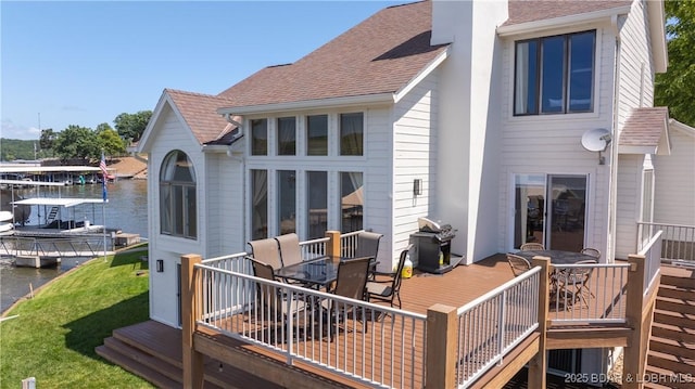 2268 Breezy Acres Rd, Osage Beach, MO 65065 - rear view of property with outdoor dining space, a shingled roof, a deck with water view, and a chimney