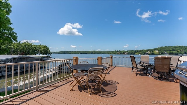2268 Breezy Acres Rd, Osage Beach, MO 65065 - wooden deck with outdoor dining space and a water view