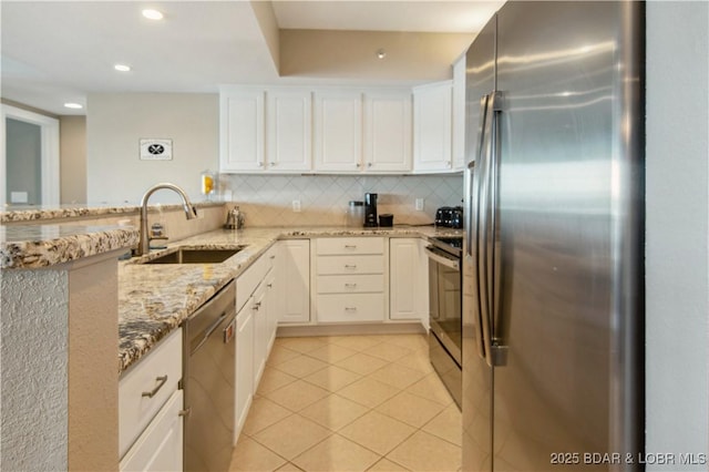 68 Lighthouse Rd Unit 906, Lake Ozark, MO 65049 - kitchen with stainless steel appliances, light tile patterned floors, white cabinetry, light stone counters, and recessed lighting