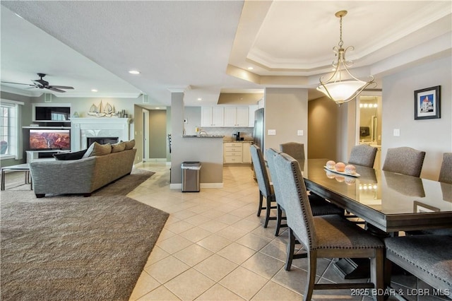 68 Lighthouse Rd Unit 906, Lake Ozark, MO 65049 - dining room featuring crown molding, light tile patterned flooring, ceiling fan, recessed lighting, and a fireplace