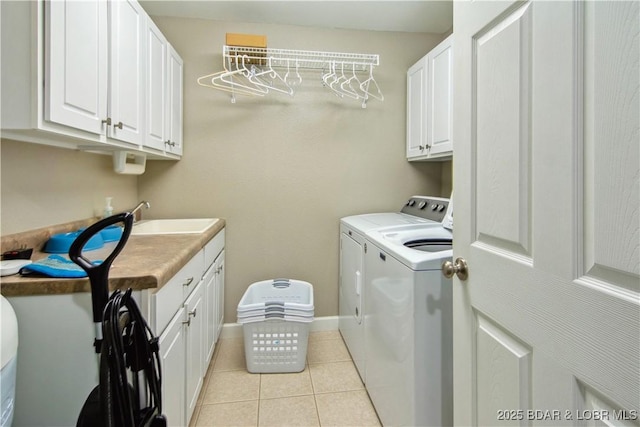 68 Lighthouse Rd Unit 906, Lake Ozark, MO 65049 - laundry area with washer and clothes dryer, cabinet space, and light tile patterned flooring