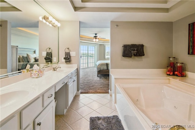 68 Lighthouse Rd Unit 906, Lake Ozark, MO 65049 - ensuite bathroom featuring a tray ceiling, double vanity, a whirlpool tub, tile patterned floors, and ceiling fan