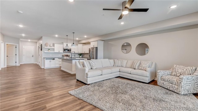 104 Sierra Bay Dr Unit 1B, Camdenton, MO 65020 - living room featuring light wood-style floors, ceiling fan, and recessed lighting