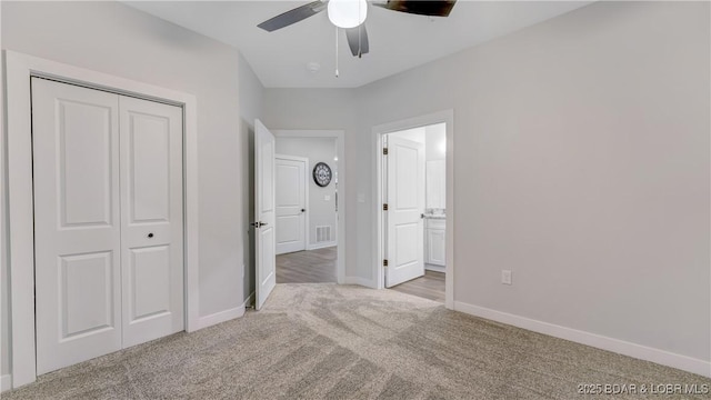 104 Sierra Bay Dr Unit 1B, Camdenton, MO 65020 - unfurnished bedroom featuring carpet, a closet, ensuite bath, and a ceiling fan