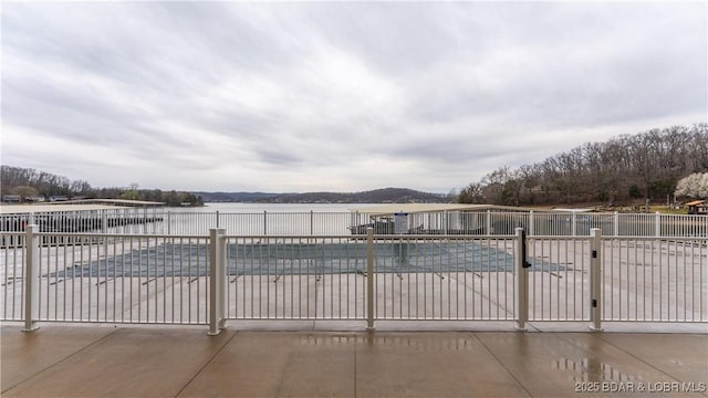 104 Sierra Bay Dr Unit 1B, Camdenton, MO 65020 - view of swimming pool featuring a water view and a patio
