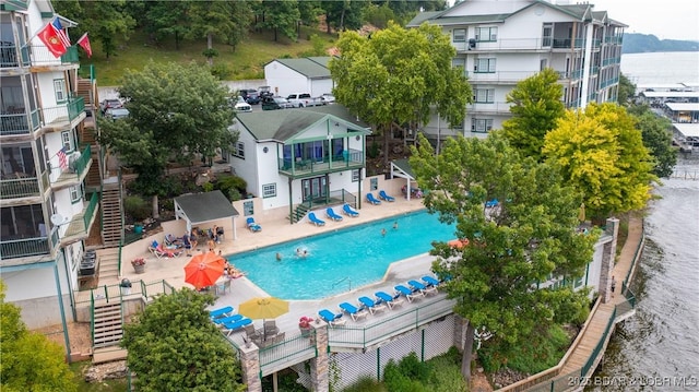 1201 W Harbour Towne Dr Unit 1201, Lake Ozark, MO 65049 - rear view of house featuring a patio, a balcony, stairway, and a community pool