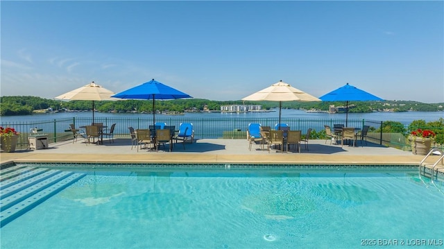 1201 W Harbour Towne Dr Unit 1201, Lake Ozark, MO 65049 - view of swimming pool with a patio, a water view, and outdoor dining area