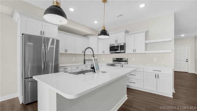 104 Sierra Bay Dr Unit 1C, Camdenton, MO 65020 - kitchen with stainless steel appliances, open shelves, white cabinetry, dark wood-type flooring, and a kitchen island with sink