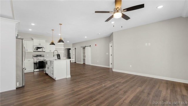 104 Sierra Bay Dr Unit 1C, Camdenton, MO 65020 - unfurnished living room with a barn door, ceiling fan, dark wood-style flooring, and recessed lighting