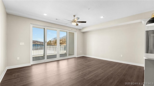 104 Sierra Bay Dr Unit 1C, Camdenton, MO 65020 - empty room with a ceiling fan, dark wood finished floors, recessed lighting, and a water view