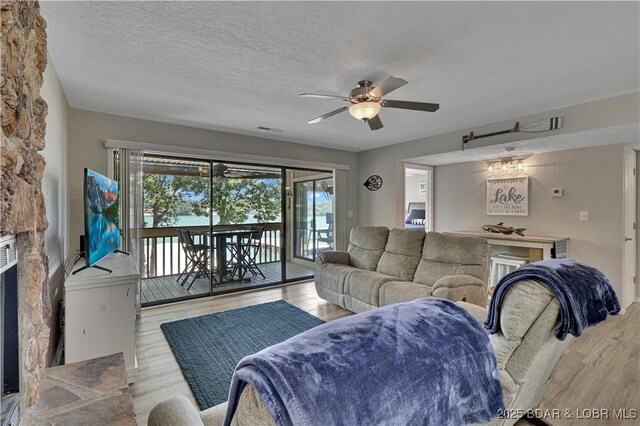2500 Bay Point Dr Unit 331, Osage Beach, MO 65065 - living area with a ceiling fan, wood finished floors, and a textured ceiling