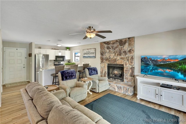 2500 Bay Point Dr Unit 331, Osage Beach, MO 65065 - living room with a ceiling fan, light wood finished floors, and a fireplace