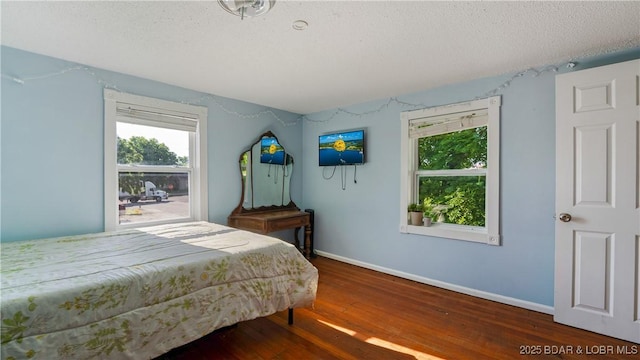 121 W 9th St, Eldon, MO 65026 - bedroom featuring hardwood / wood-style floors and a textured ceiling