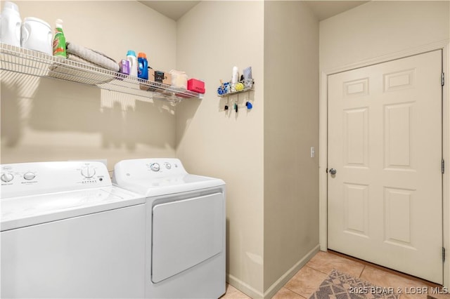 396 Elm Tree Ln, Camdenton, MO 65020 - washroom featuring washing machine and dryer and light tile patterned flooring