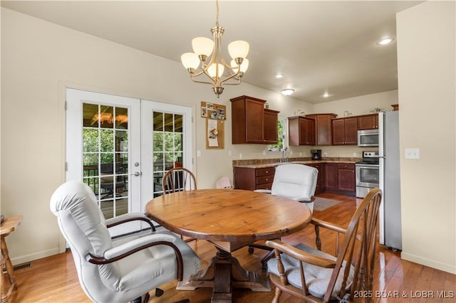 396 Elm Tree Ln, Camdenton, MO 65020 - dining room featuring french doors, light wood-style floors, recessed lighting, and a chandelier