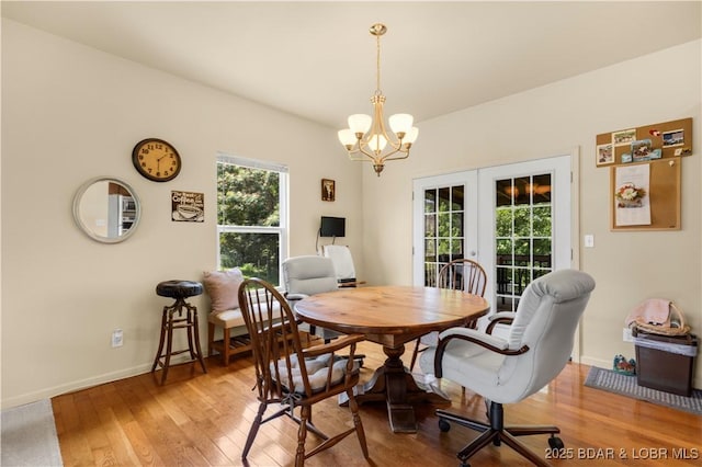 396 Elm Tree Ln, Camdenton, MO 65020 - dining room featuring french doors, a desk, light wood-style floors, and a chandelier