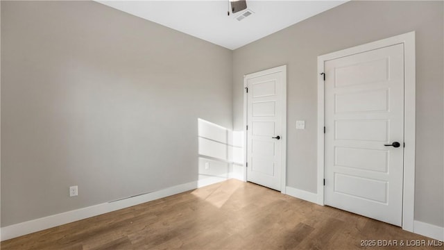 60 Lady Bug Ln, Camdenton, MO 65020 - unfurnished bedroom with wood finished floors and baseboards