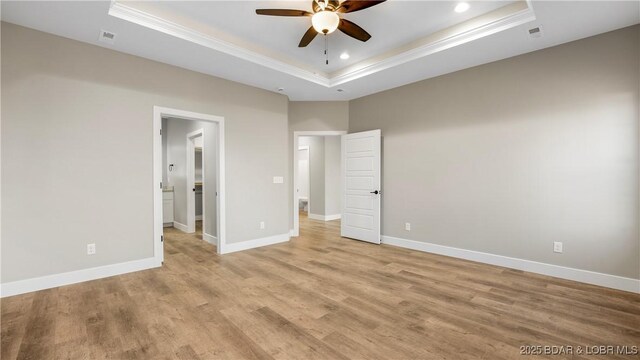 60 Lady Bug Ln, Camdenton, MO 65020 - unfurnished bedroom featuring a raised ceiling, ornamental molding, light wood-style flooring, and recessed lighting
