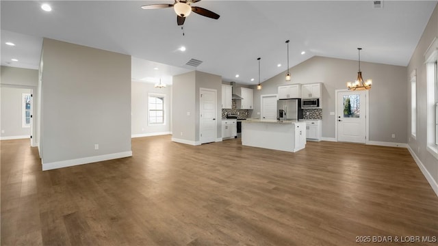 60 Lady Bug Ln, Camdenton, MO 65020 - unfurnished living room featuring a chandelier, a ceiling fan, wood finished floors, high vaulted ceiling, and recessed lighting